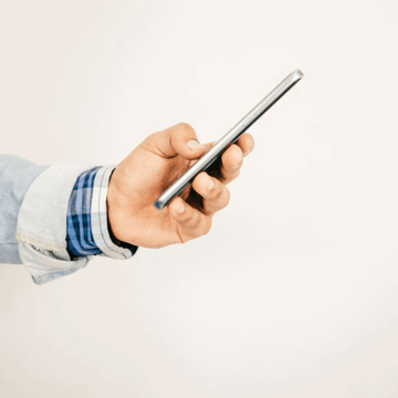 hand holding a smartphone (side-view)